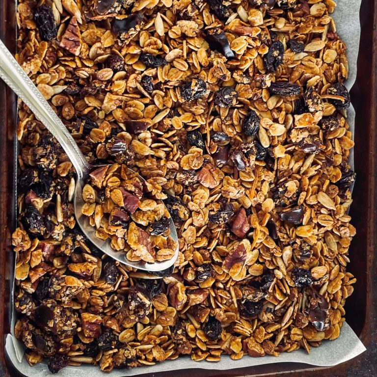 Maple Pecan Granola in tray with a spoon. A Healthy Breakfast Option