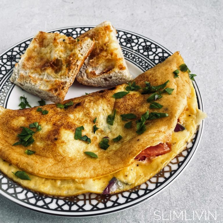 Healthy cheese and vegetable omelette on a plate with some toast